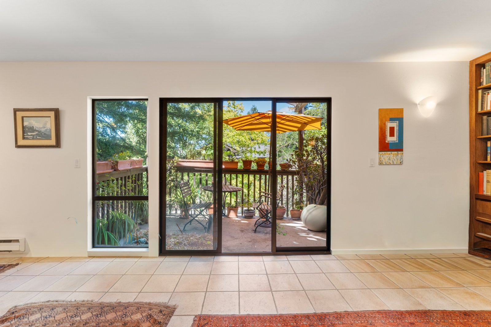 Sunlit interior opening to a private redwood deck at 62 Pearce Mitchell Place