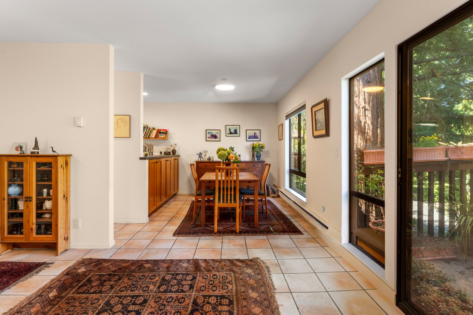 Dining area with tile flooring and layered furnishings