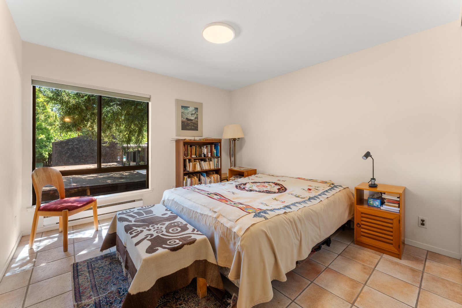 Sunlit bedroom with tree views